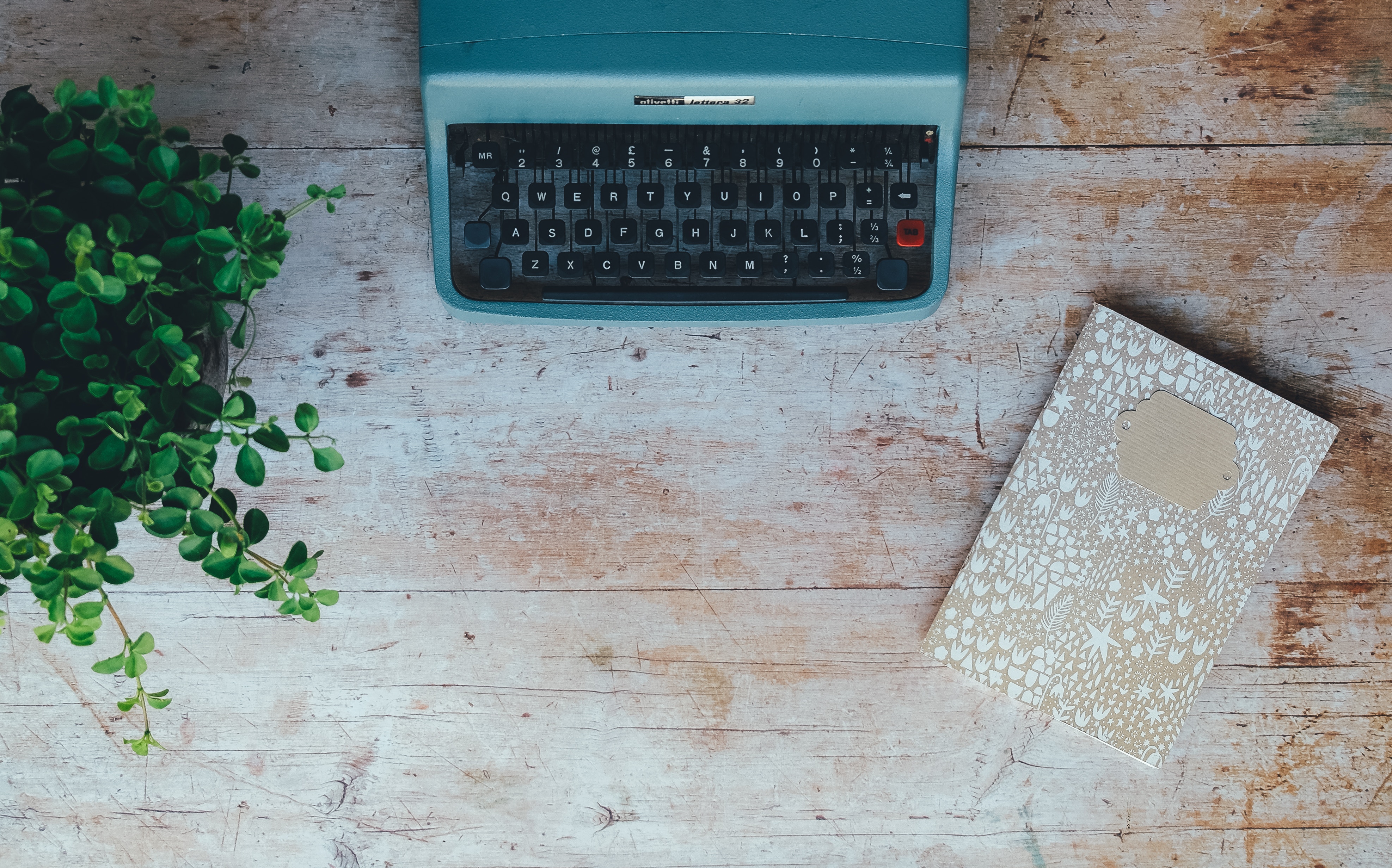 Cyan typewritter at wooden desk